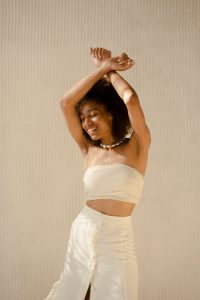 Image of a Black woman dancing. This image represents what dance looks like when practicing mind-body medicine techniques learned from a holistic therapist in Baltimore, MD. 21204 | 21286 | 21044
