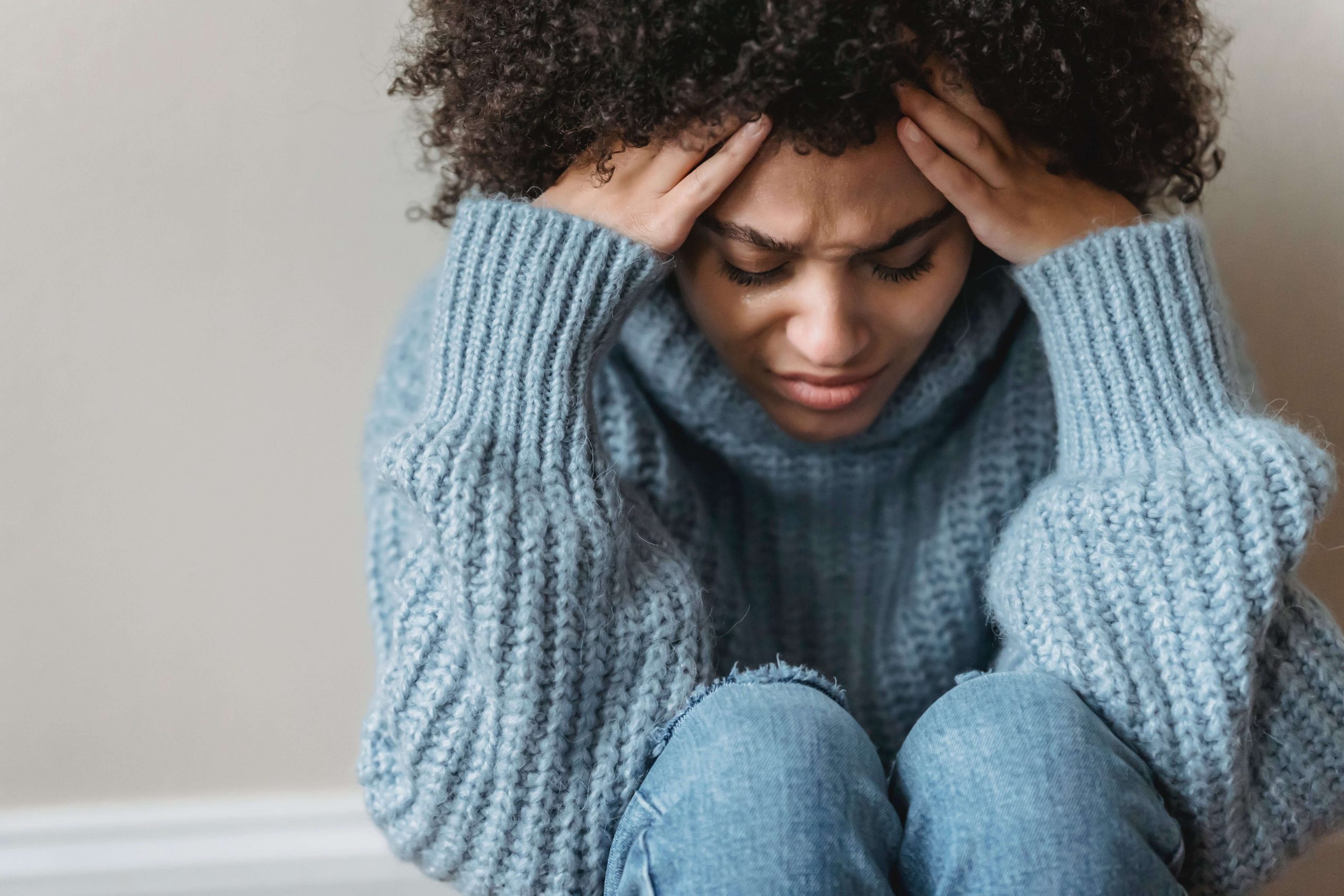 A woman holds her head as she deals with adrenal fatigue in Baltimore, MD that has her feeling tired and stressed. Learn how adrenal fatigue in Baltimore, MD can offer support by contacting a black therapist in Baltimore today. They can offer mind-body counseling in Baltimore, MD, and more.